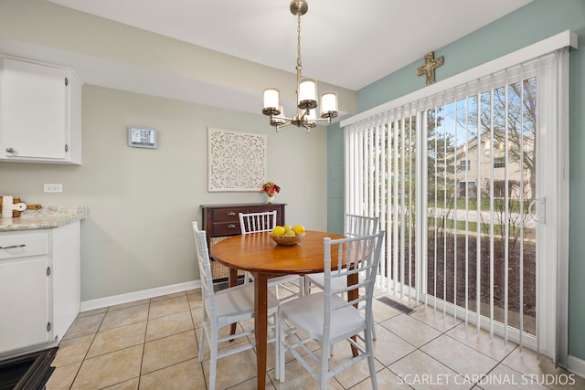dining room featuring a notable chandelier, baseboards, and light tile patterned flooring