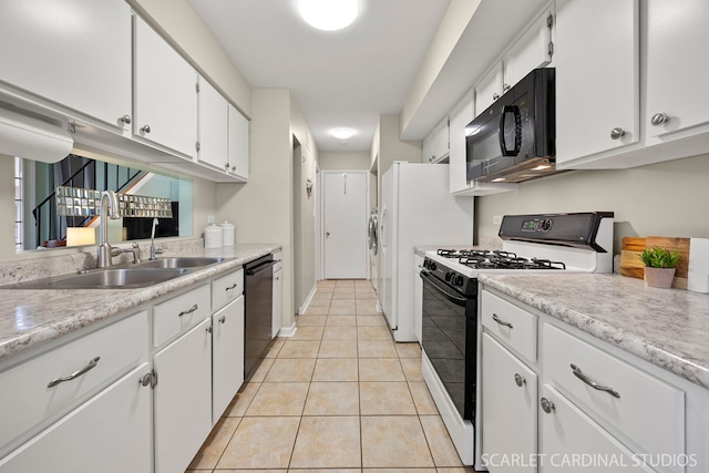kitchen with white cabinets, light countertops, a sink, and black appliances