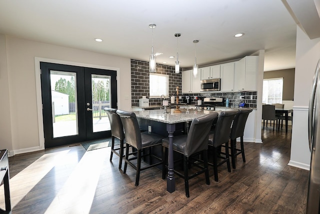 dining space with recessed lighting, baseboards, dark wood-style floors, and french doors