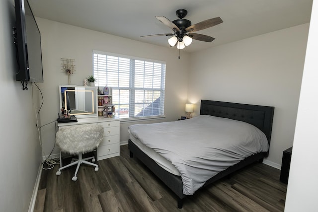 bedroom featuring baseboards, dark wood-style flooring, and ceiling fan