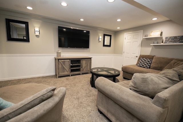 carpeted living room featuring recessed lighting and a wainscoted wall