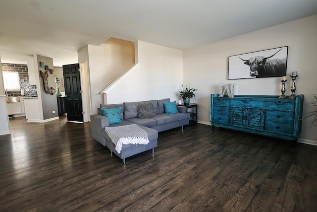 living area featuring baseboards and wood finished floors