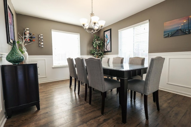 dining room with a chandelier, wainscoting, and a wealth of natural light