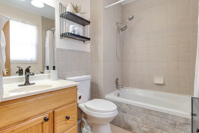full bathroom featuring toilet, vanity, tile walls, and tiled shower / bath combo