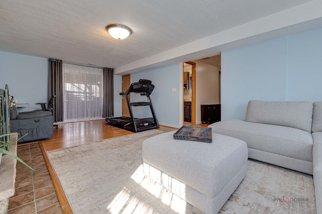 living area with a textured ceiling and wood finished floors