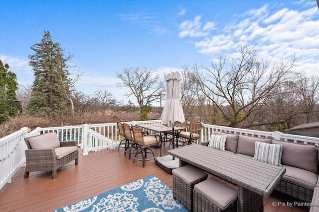 wooden deck with an outdoor living space and outdoor dining area