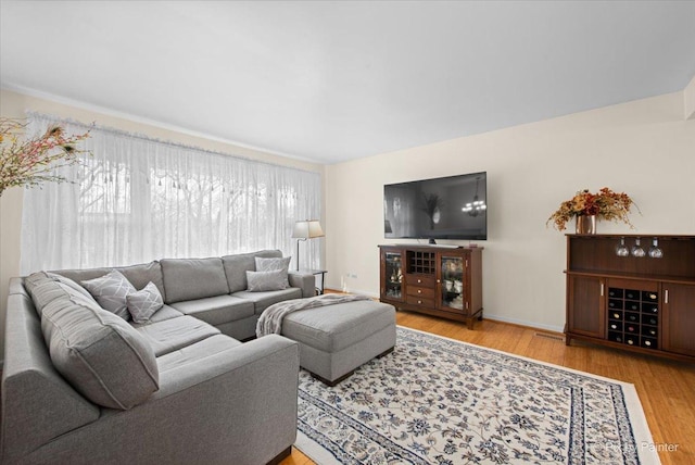living room featuring baseboards and wood finished floors