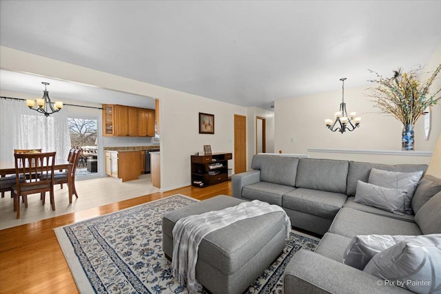 living room with light wood finished floors and a notable chandelier