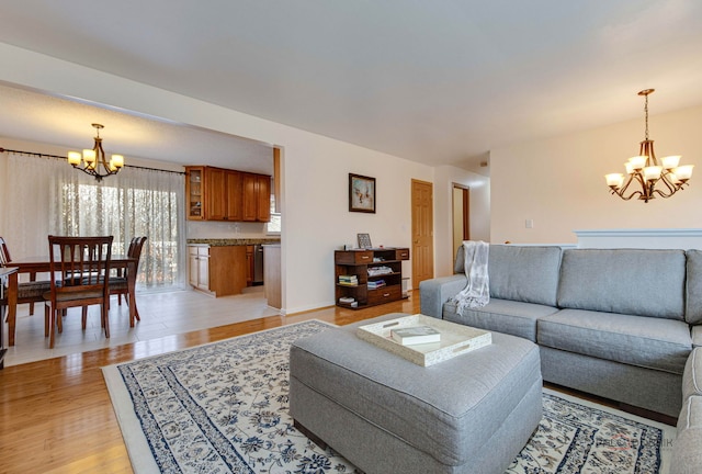 living area with light wood-style flooring and a chandelier