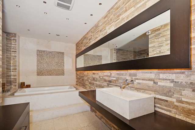 2441 Woodbridge Ln, Highland Park, IL 60035 - full bath with tile walls, tile patterned floors, vanity, and a garden tub