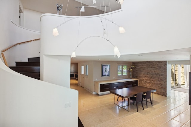 2441 Woodbridge Ln, Highland Park, IL 60035 - dining area with light tile patterned floors, stairway, and a towering ceiling