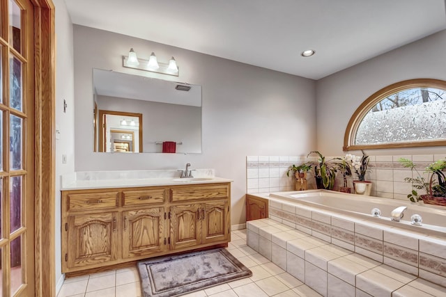 bathroom featuring tile patterned flooring, vanity, recessed lighting, baseboards, and a garden tub