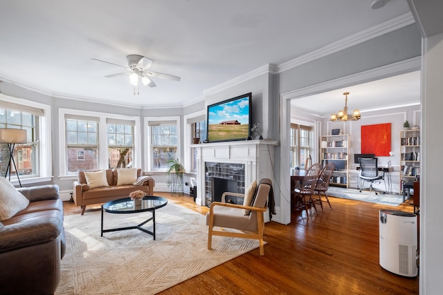 230 N Oak Park Ave Unit 2I, Oak Park, IL 60302 - living room with crown molding, ceiling fan with notable chandelier, wood finished floors, a tiled fireplace, and a baseboard radiator