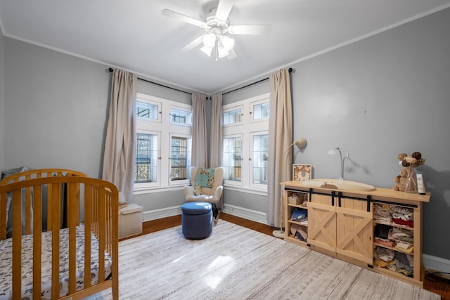 230 N Oak Park Ave Unit 2I, Oak Park, IL 60302 - bedroom with wood finished floors, ceiling fan, baseboards, and a nursery area