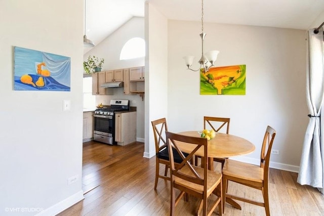 204 E Heritage Trl E, Hainesville, IL 60030 - dining space featuring baseboards, high vaulted ceiling, wood finished floors, and a notable chandelier