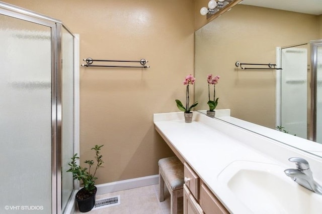 204 E Heritage Trl E, Hainesville, IL 60030 - full bathroom with visible vents, a stall shower, baseboards, vanity, and tile patterned flooring