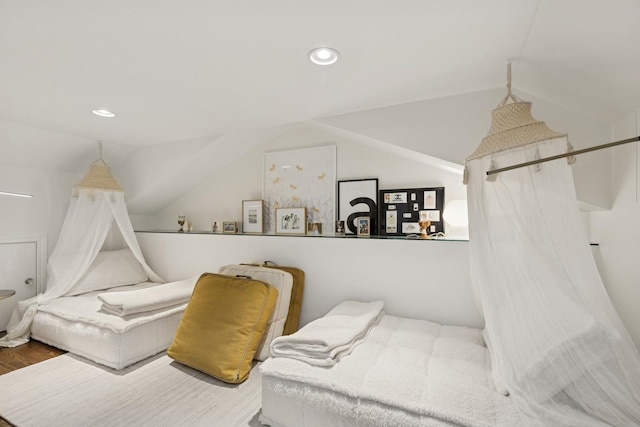 bedroom with lofted ceiling, wood finished floors, and recessed lighting