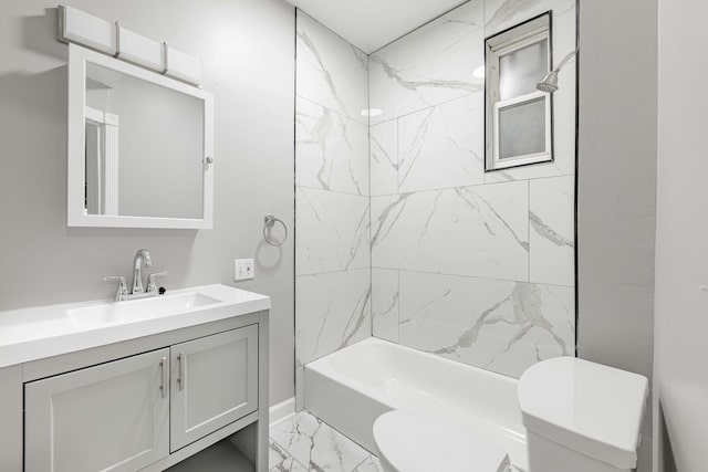 full bath with shower / bathing tub combination, toilet, marble finish floor, and vanity