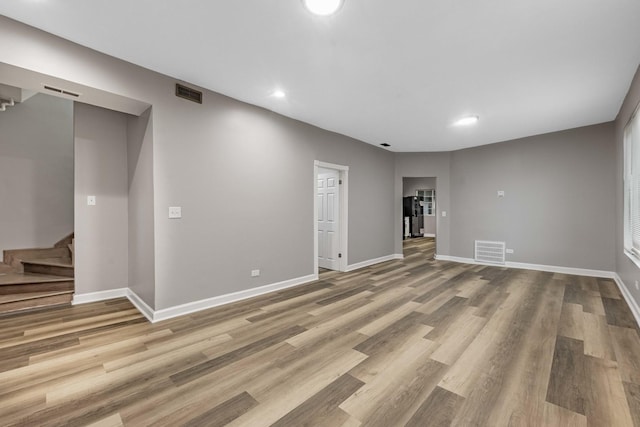 interior space featuring visible vents, baseboards, and wood finished floors