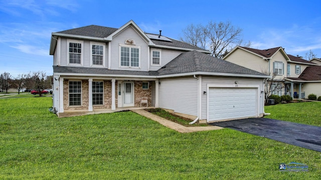 153 Christine Way, Bolingbrook, IL 60440 - traditional home with an attached garage, a front lawn, aphalt driveway, and solar panels