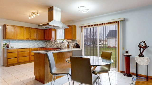 153 Christine Way, Bolingbrook, IL 60440 - kitchen featuring brown cabinetry, tasteful backsplash, island exhaust hood, and a peninsula