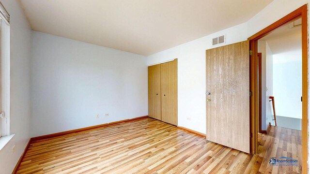 153 Christine Way, Bolingbrook, IL 60440 - unfurnished bedroom with light wood-style flooring, a closet, baseboards, and visible vents