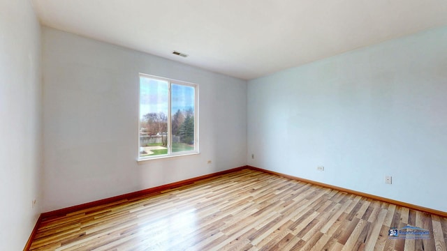 153 Christine Way, Bolingbrook, IL 60440 - unfurnished room with visible vents, baseboards, and wood finished floors