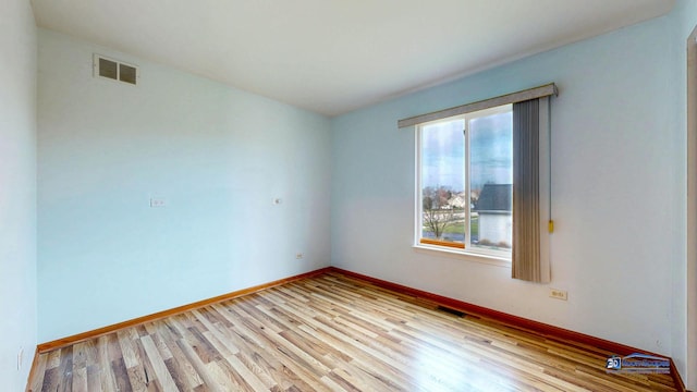 153 Christine Way, Bolingbrook, IL 60440 - spare room with visible vents, light wood-type flooring, and baseboards