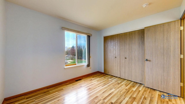 153 Christine Way, Bolingbrook, IL 60440 - unfurnished bedroom with light wood-type flooring, a closet, baseboards, and visible vents