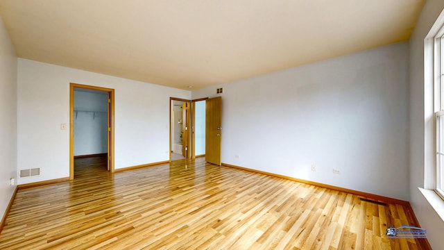 153 Christine Way, Bolingbrook, IL 60440 - spare room with light wood finished floors, visible vents, and baseboards