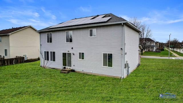 153 Christine Way, Bolingbrook, IL 60440 - back of property with entry steps, a lawn, and roof mounted solar panels