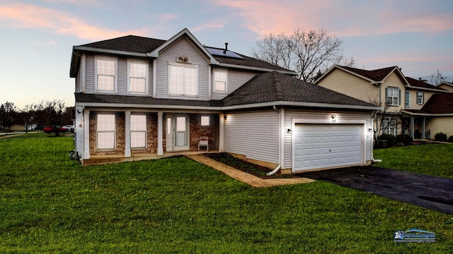 153 Christine Way, Bolingbrook, IL 60440 - traditional-style house featuring roof mounted solar panels, a garage, a front lawn, a shingled roof, and driveway
