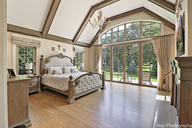 bedroom with beamed ceiling, light wood-type flooring, a chandelier, access to exterior, and an AC wall unit