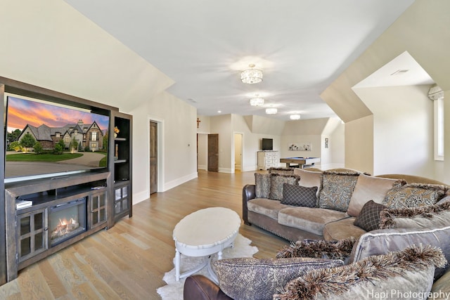 living area featuring baseboards and wood finished floors