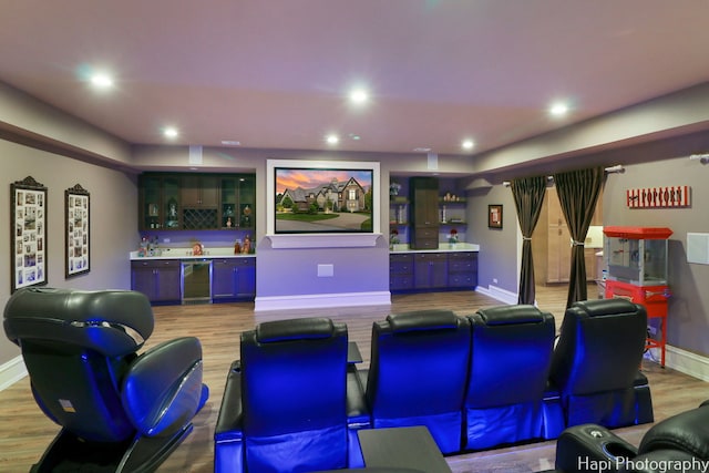 cinema featuring baseboards, recessed lighting, wet bar, and wood finished floors
