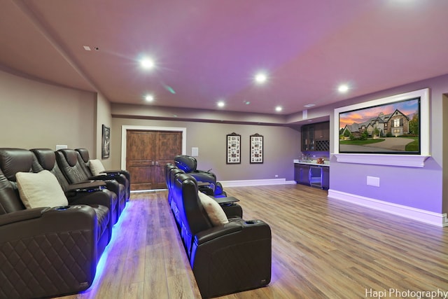 home theater room featuring light wood-style flooring, recessed lighting, and baseboards