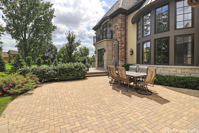 view of patio / terrace featuring outdoor dining space and a balcony