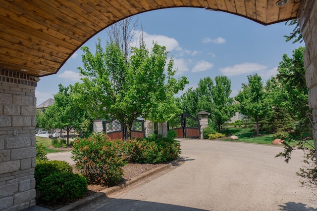 exterior space with curbs and a gate
