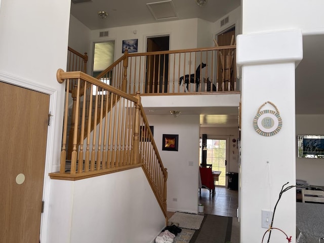 370 W Asbury Dr, Round Lake, IL 60073 - staircase featuring a towering ceiling and tile patterned floors