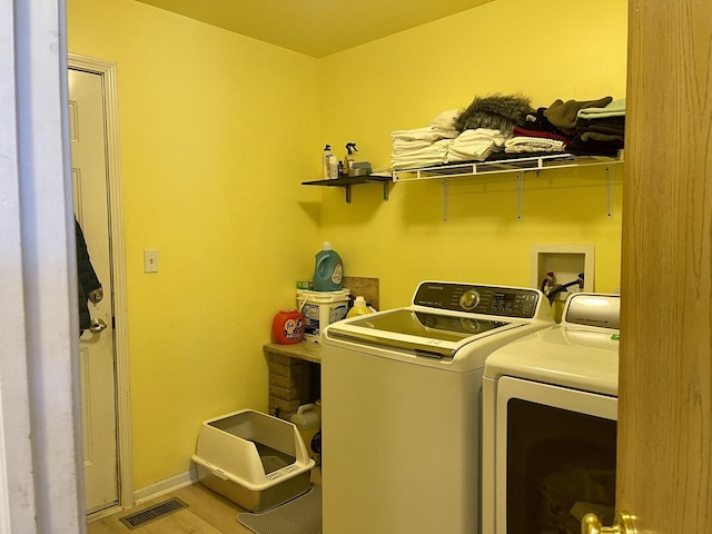 370 W Asbury Dr, Round Lake, IL 60073 - laundry room featuring separate washer and dryer and light wood-style floors