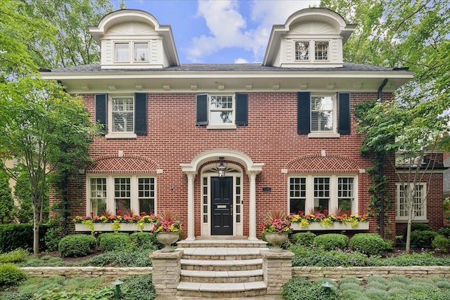 colonial-style house with brick siding