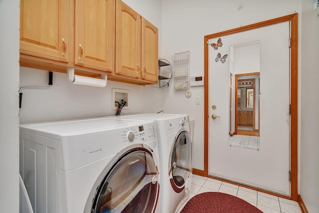 laundry area with cabinet space, washing machine and clothes dryer, baseboards, and light tile patterned floors