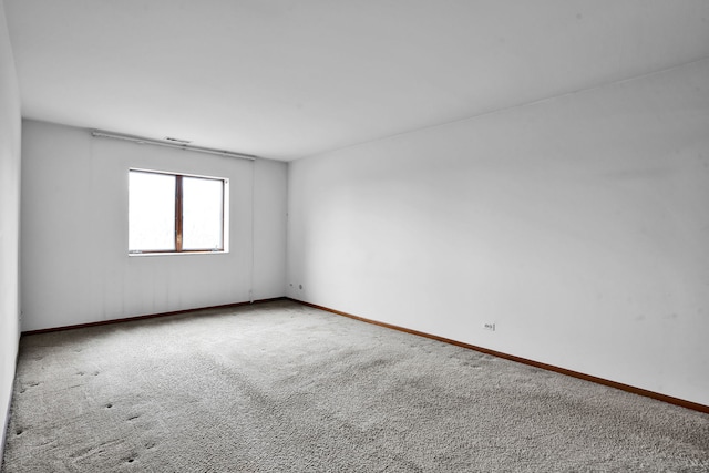 empty room with carpet floors and baseboards