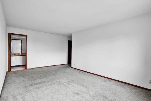 carpeted spare room with baseboards