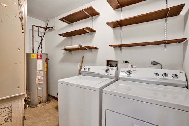 laundry area with electric water heater, light tile patterned floors, washing machine and clothes dryer, and laundry area