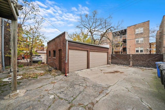 detached garage featuring fence