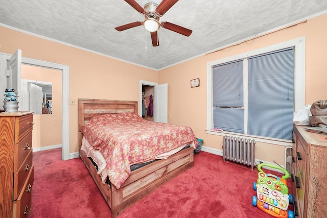 bedroom featuring a textured ceiling, baseboards, radiator, and carpet floors