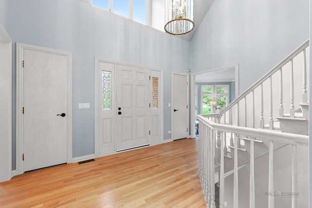 318 Camelot Ln, Libertyville, IL 60048 - entrance foyer with a high ceiling, wood finished floors, a chandelier, stairway, and baseboards