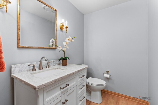 full bathroom featuring double vanity, a sink, and baseboards