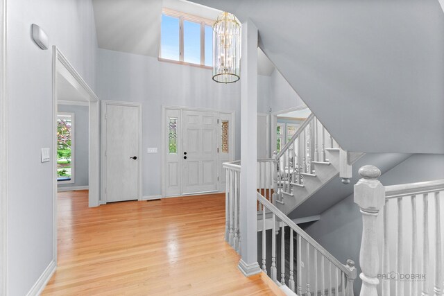 dining area featuring an inviting chandelier, baseboards, crown molding, and light wood-type flooring